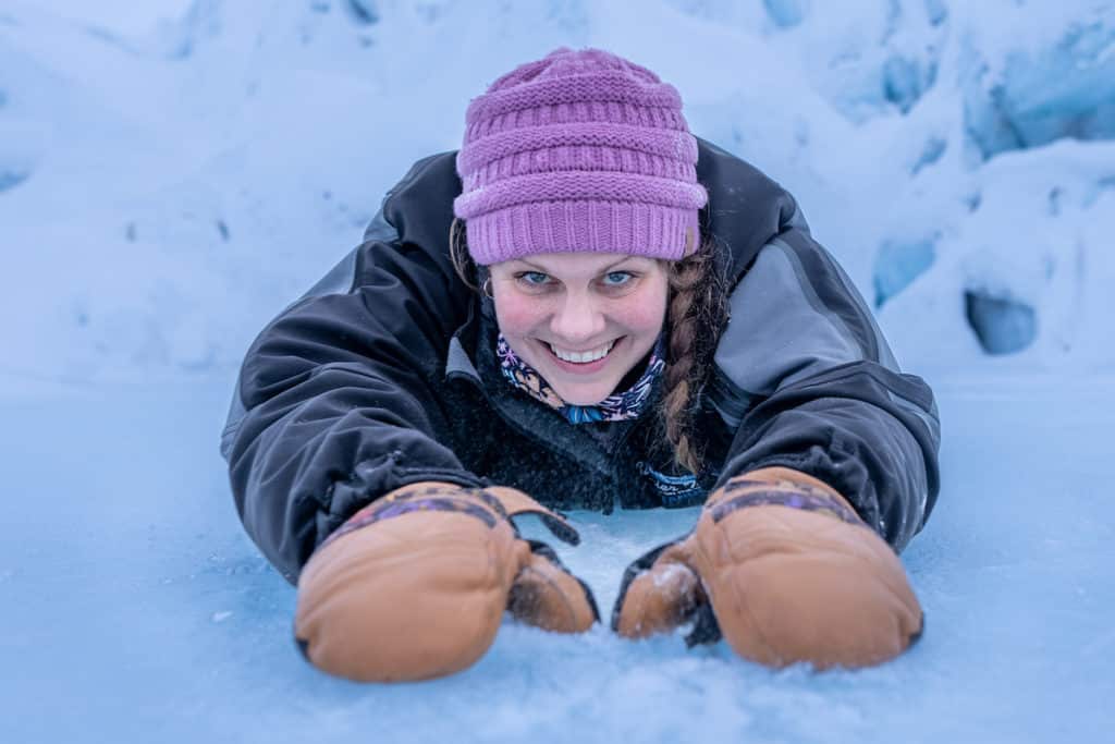 Tour Guide Showing How To Do The Penguin Slide On The Frozen Glacier