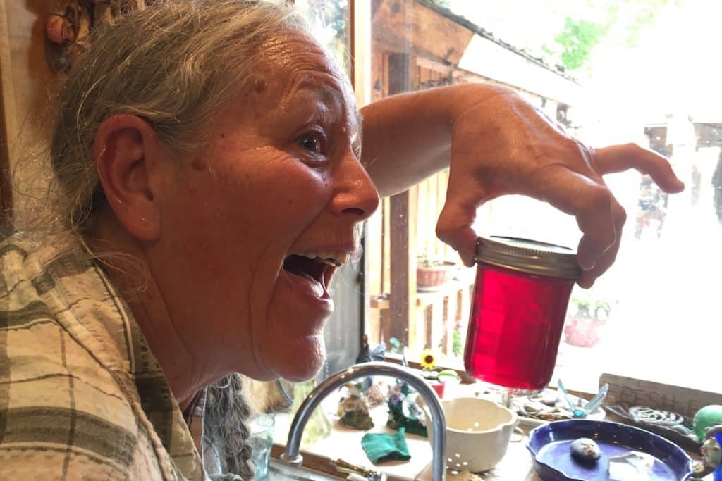 Bev holding a jar of Alaskan fireweed jelly